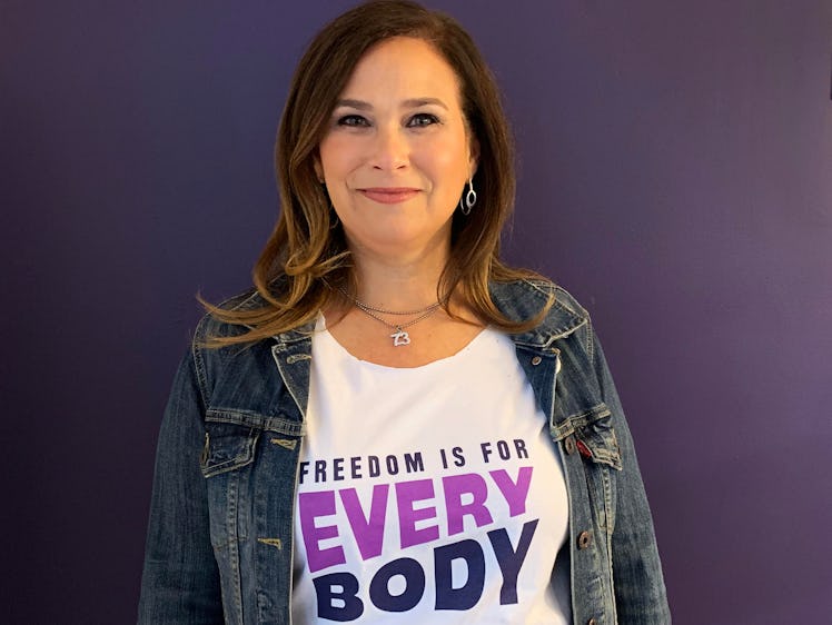 NARAL President Ilyse Hogue poses in a shirt reading "Freedom is for every body"