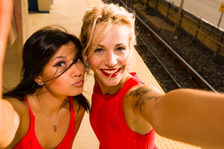 Two girl friends wearing red dresses, Valentine's Day