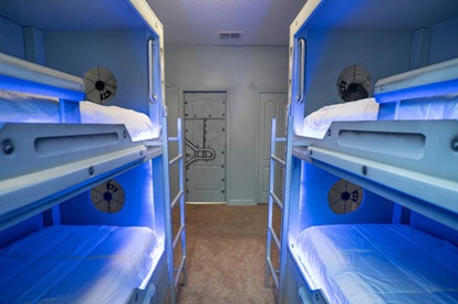 Bunk beds in one of the bedrooms in a 'Star Wars'-themed Airbnb light up with blue lights. 