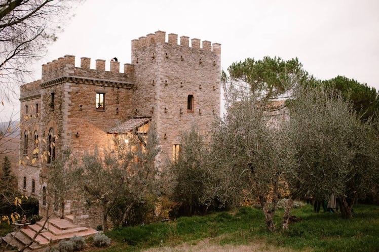 This medieval castle listed on Airbnb is surrounded by trees in the countryside of Florence.  