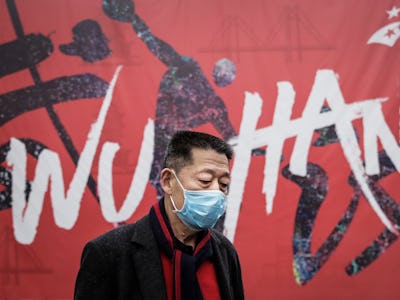 WUHAN, CHINA - JANUARY 22: (CHINA OUT) A man wears a mask while walking in the street on January 22,...