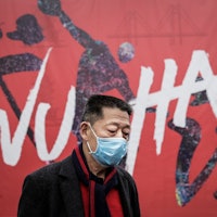 WUHAN, CHINA - JANUARY 22: (CHINA OUT) A man wears a mask while walking in the street on January 22,...