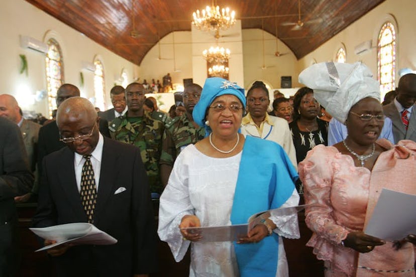 Liberian President elect Ellen Johnson-Sirleaf, sings during a church service in Monrovia, Liberia i...