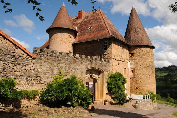 Green bushes sit outside a castle home in France that's listed on Airbnb.