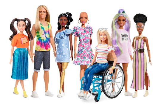 a collection of Barbies. Left to right: Barbie with brunette pigtails, shorter stature, long haired ...