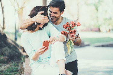 Boyfriend surprising girlfriend with flowers on Valentine's Day