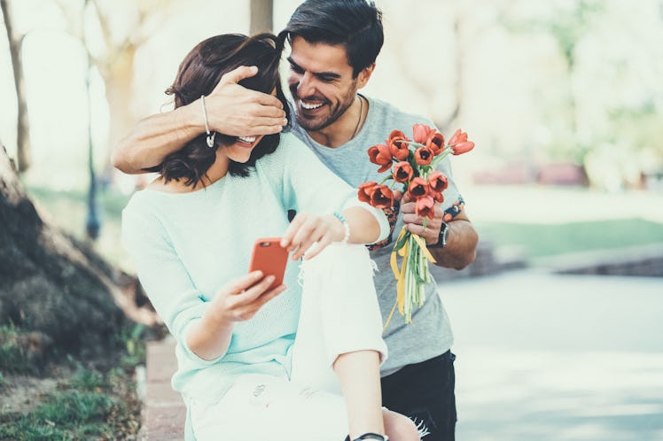 Boyfriend surprising girlfriend with flowers on Valentine's Day