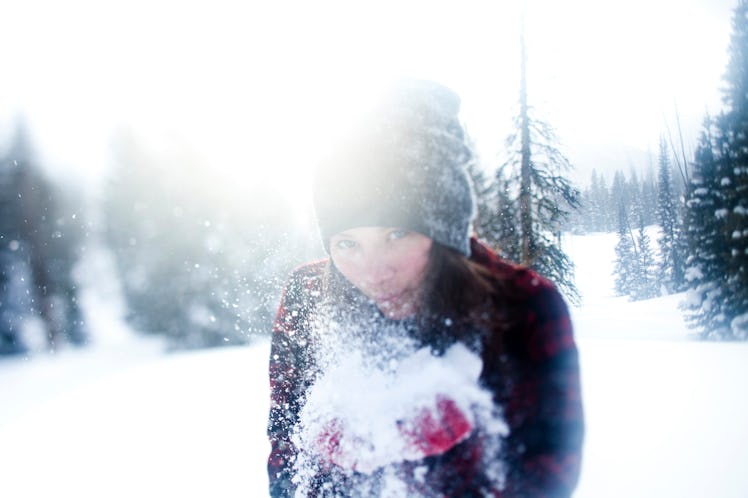 Young woman blowing snow