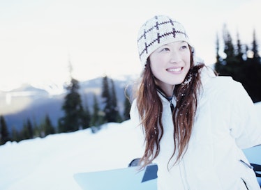 Young Asian woman happy in snow, winter