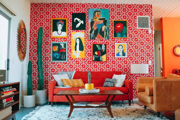 The living room in a Mid-Century Palm Springs home has colorful furniture and painting on the wall. 