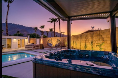 A jacuzzi sits in the backyard of a Palm Springs home at sunset.