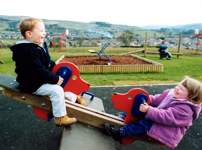 Small children playing on seesaw in North Yorkshire. 