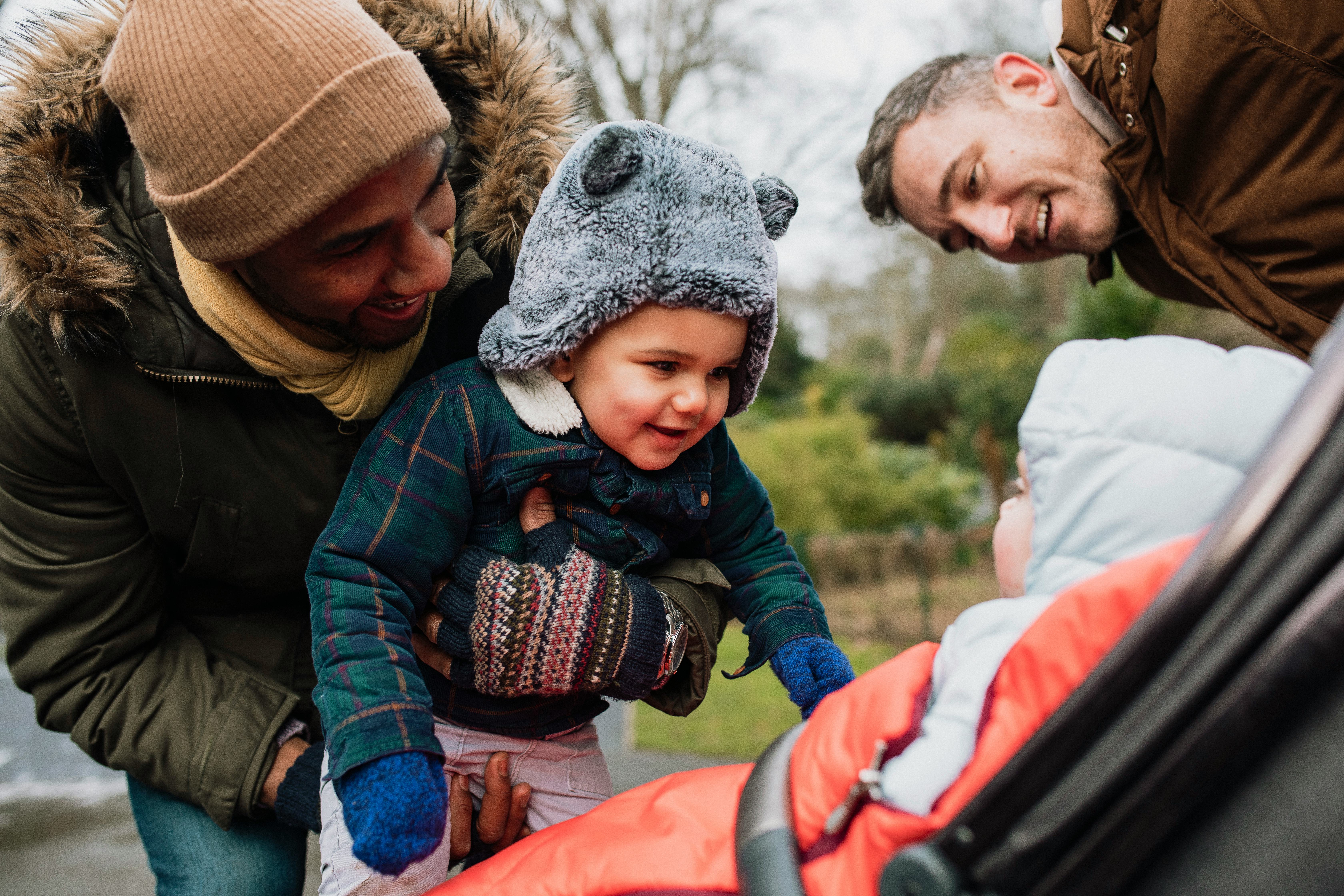 two dads introduce their toddlers on a cold winter's day