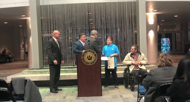 A picture of young Josh Cudzey being awarded the "Citizen of the Day," award. 
