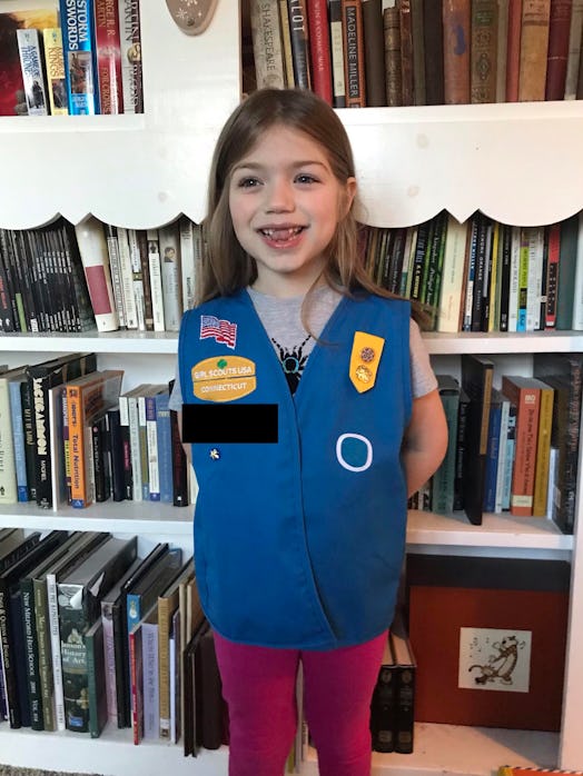 A girl wearing a girl scout uniform.