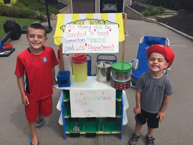 Two boys in front of their lemonade stand.