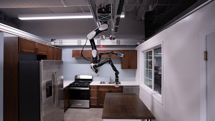 Toyota created a robot that hangs from the ceiling and is able to complete tasks like cleaning and l...