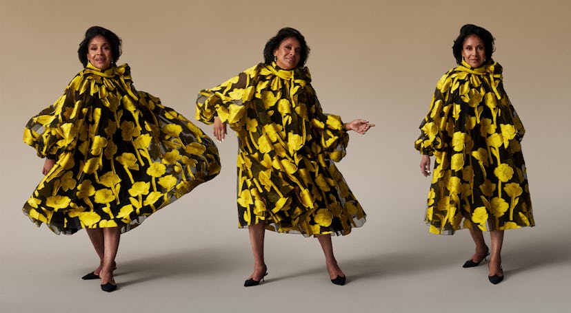 Phylicia Rashad in a black yellow flower motived dress and scarf