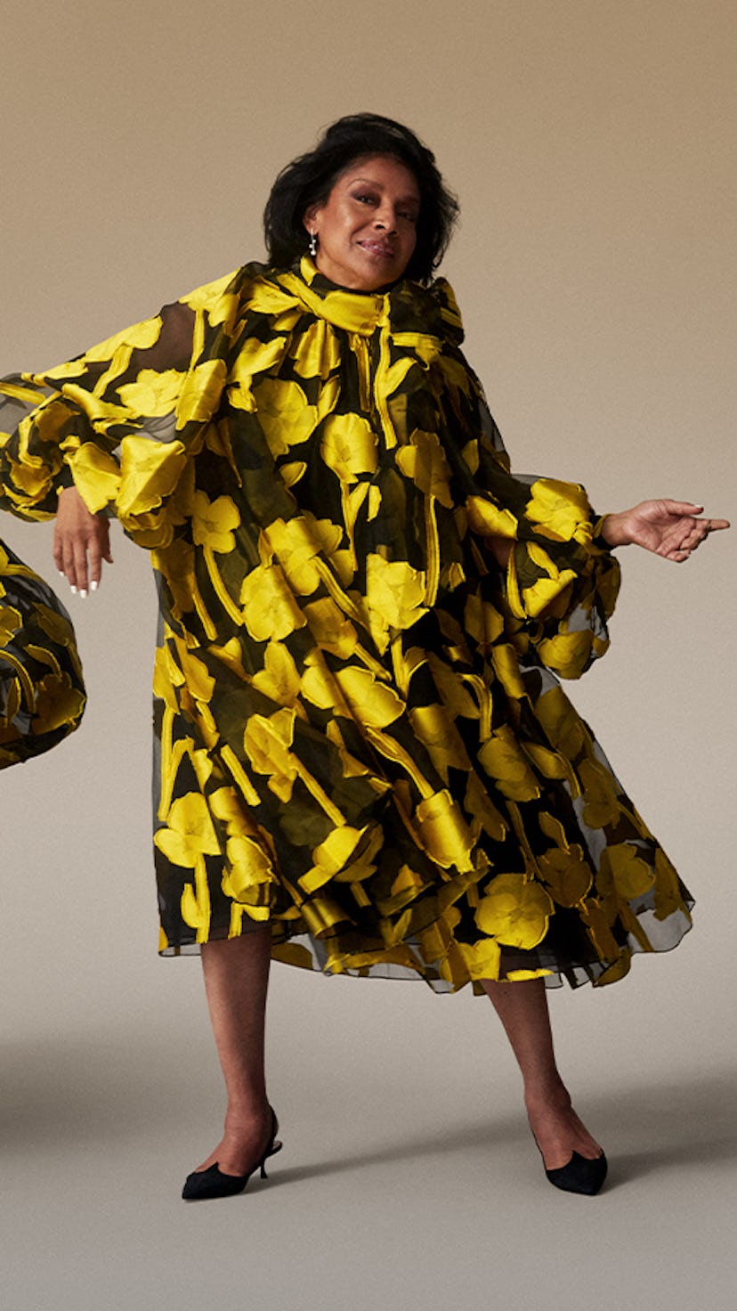 Phylicia Rashad in a black yellow flower motived dress and scarf