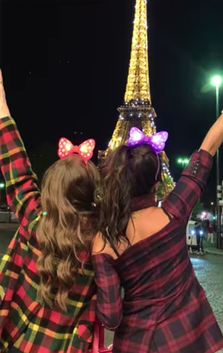 Emily (Lily Collins) and Mindy (Ashley Park) look out at the Eiffel Tower in Paris. 