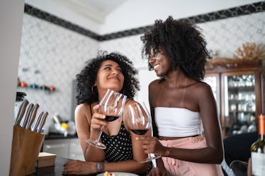 2 young female friends drinking wine