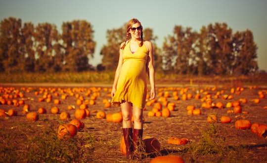 pregnant woman in a pumpkin patch