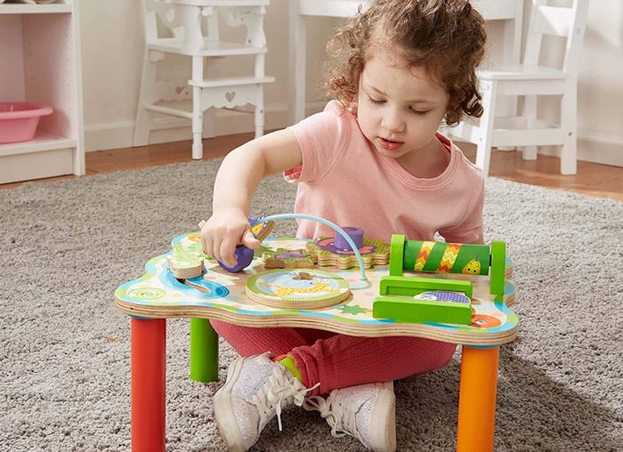 little girl sitting at a melissa & doug table