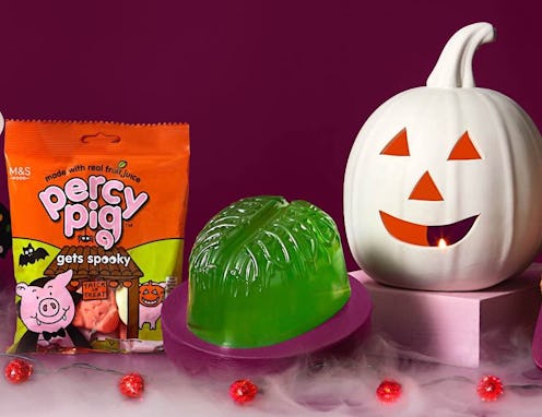 A bag of percy pig gets spooky sweets, a jewlly zombie brain, and a white pumpkin lantern arranged a...