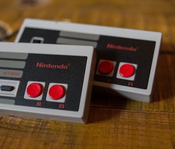 Two NES (Nintendo Entertainment System) Classic Mini controllers.