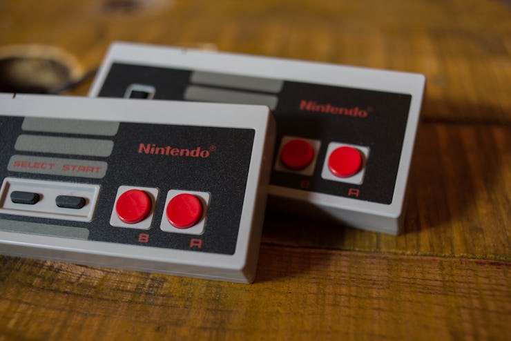 Two NES (Nintendo Entertainment System) Classic Mini controllers.