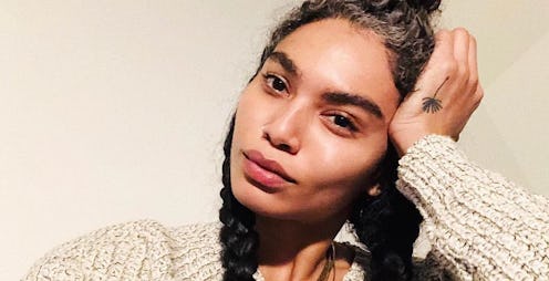 Sophia Roe taking a selfie while wearing a beige sweater, resting her head in her hand and staring a...