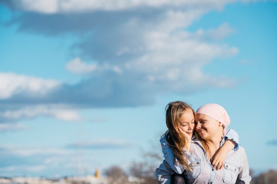 mom, breast cancer survivor, and daughter laughing