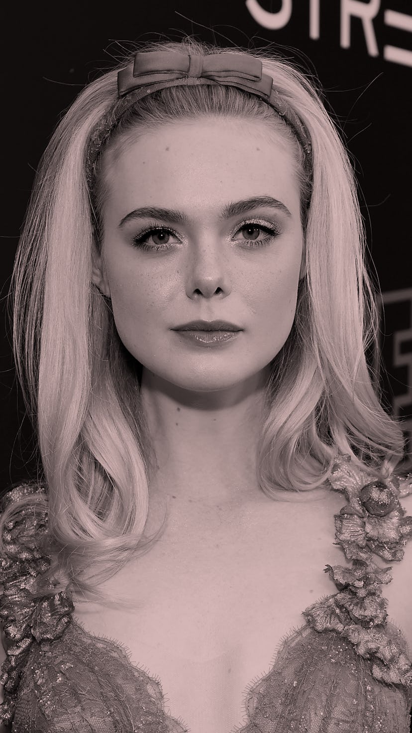 Elle Fanning on the red carpet in a pink tulle gown with flowers on the straps and a headband with ...