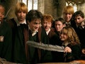 Harry Potter and his friends look at a gift with a feather in it from 'Harry Potter and the Prisoner...