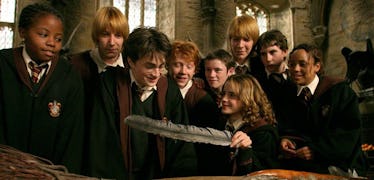 Harry Potter and his friends look at a gift with a feather in it from 'Harry Potter and the Prisoner...