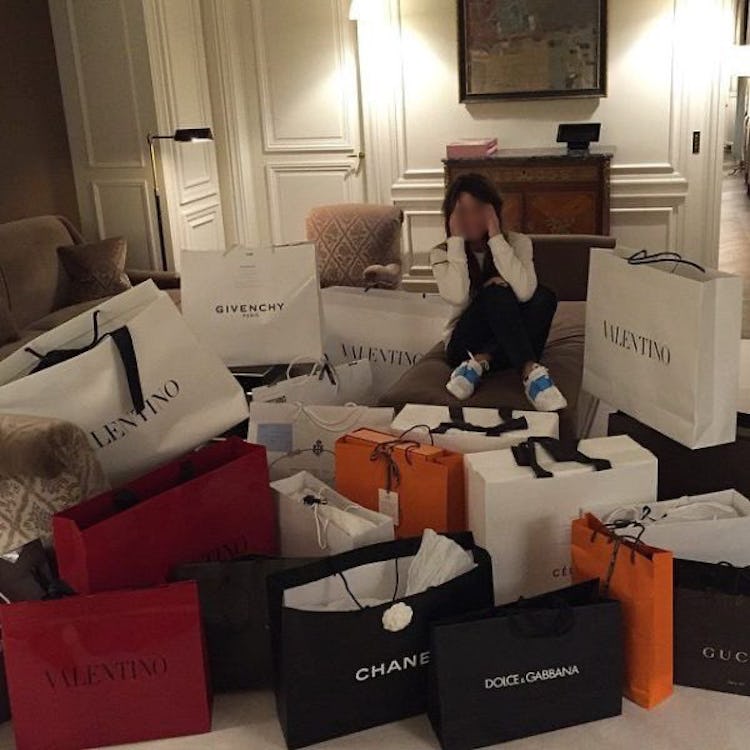 A photo of an influencer surrounded by shopping bags.