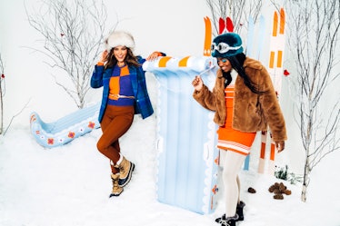 Two young women pose next to new pieces from the FUNBOY winter 20/21 SNOW collection while wearing c...