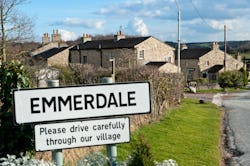 An emmerdale road sign outside a picturesque village