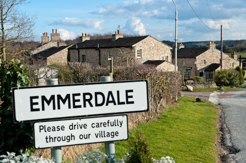 An emmerdale road sign outside a picturesque village