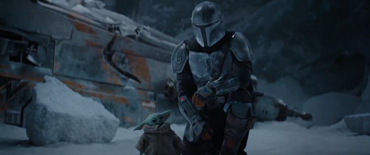 In the season two trailer for 'The Mandalorian,' Mando kneels next to The Child in a snowy town.