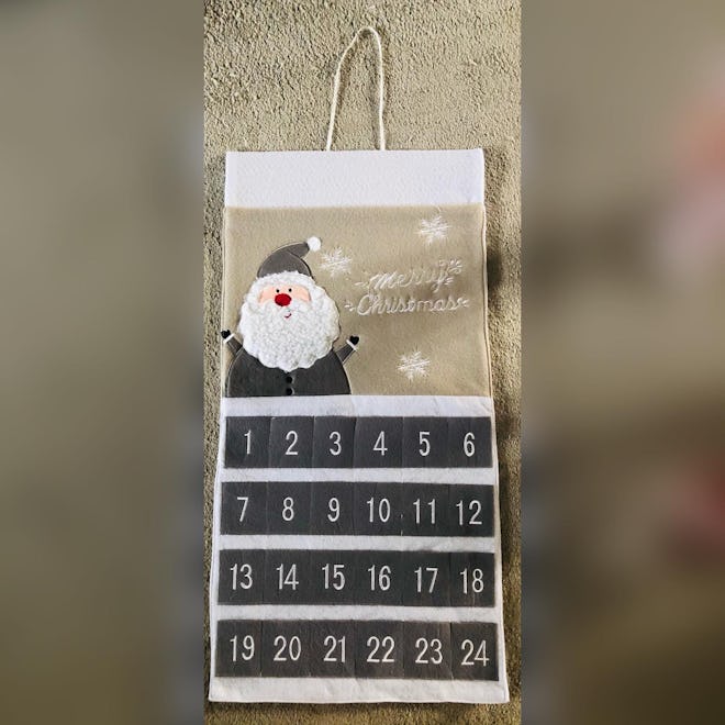 Christmas advent calendar material hanging with Santa on grey and white