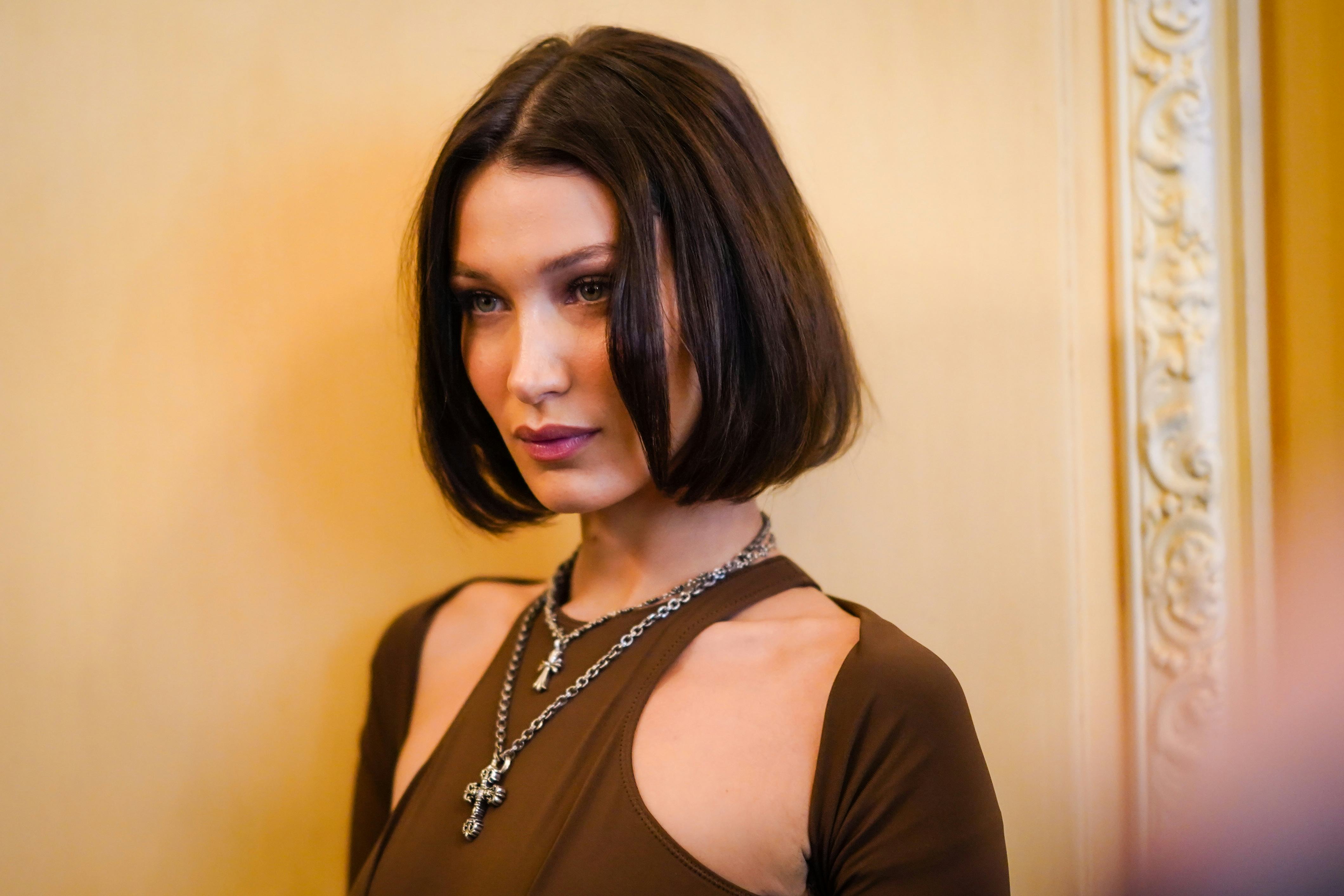 Model Bella Hadid with a middle-part brown bob.