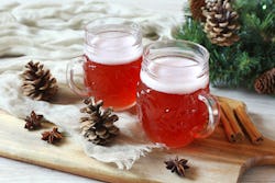 Two spiked apple ciders on a wintertime scene. What alcohol goes best with apple cider? Alcohol pros...