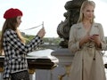 Emily (Lily Collins) snaps a picture of a model on the Pont Alexandre III bridge in Paris. 