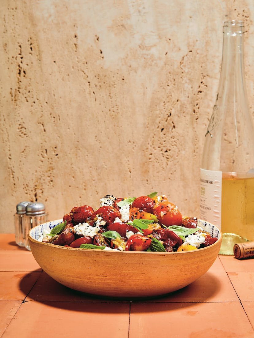 Combine roasted and fresh cherry tomatoes to create this warm salad recipe