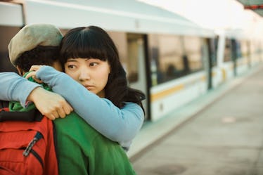 Couple hugging at train station