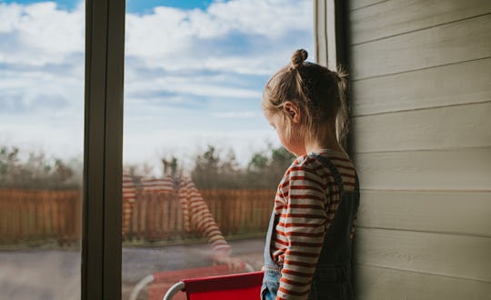 A child crying and looking outside — experts say you can validate their emotions to make them feel b...