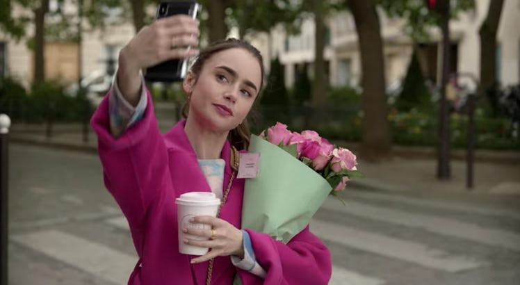 Emily (Lily Collins) poses for a selfie with a bouquet of roses in Paris, which she'll post on Insta...