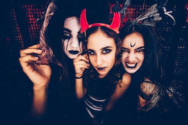 3 friends in spooky costumes on Halloween