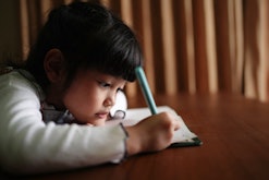 little girl doing schoolwork at home